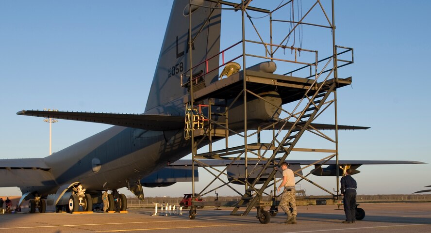 Airmen from the 20th Aircraft Maintenance Unit place a drogue chute stand behind a B-52H Stratofortress on Barksdale Air Force Base, La., Feb. 22. The stand provides Airmen stability and convenience when packing the chute equipment into the aircraft.  (U.S. Air Force photo/Airman 1st Class Benjamin Gonsier)(RELEASED)