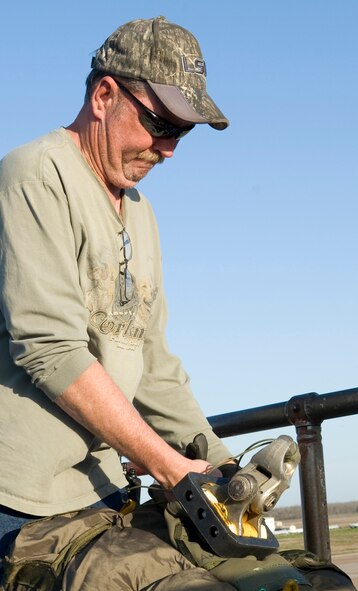 Tech. Sgt. Rob Johnson, 307th Aircraft Maintenance Squadron, cuts a chute cord on Barksdale Air Force Base, La., Feb. 21. Johnson prepped the chute bag to be placed inside a B-52H Stratofortress. (U.S. Air Force photo/Airman 1st Class Benjamin Gonsier)(RELEASED)