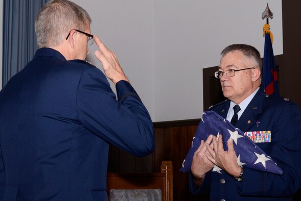Col. Timothy E. Tarchick, 94th Airlift Wing commander, renders a salute after passing the flag to Lt. Col. Chaplain William B. Ferrell during the flag folding portion of his retirement ceremony at the Dobbins Air Reserve Base Chapel Feb. 4. (U.S. Air Force photo/Don Peek)