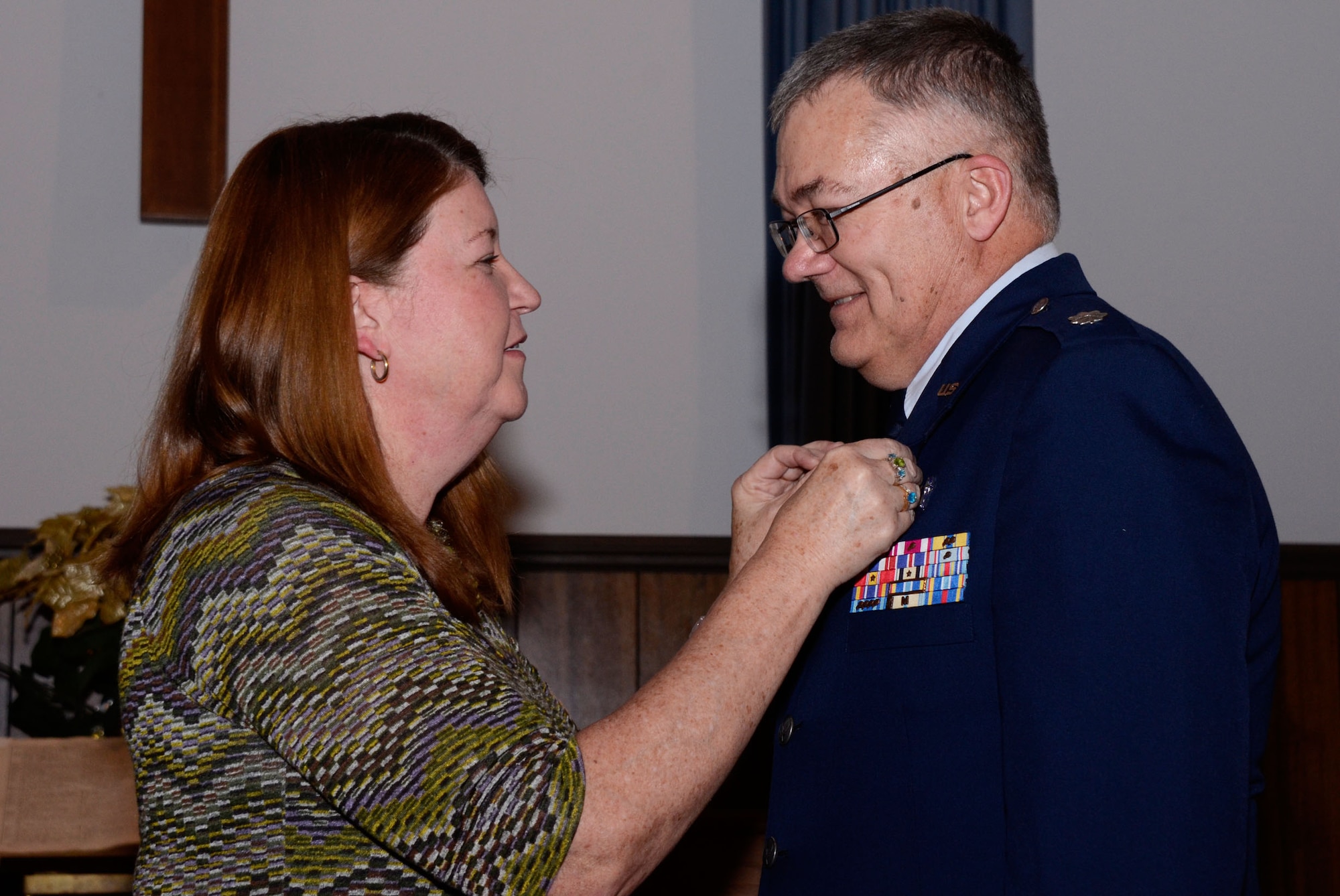 Lynn Ferrell pins on the retirement pin on Lt. Col. Chaplain William B. Ferrell during his retirement ceremony at the Dobbins Air Reserve Base Chapel Feb. 4. (U.S. Air Force photo/Don Peek)