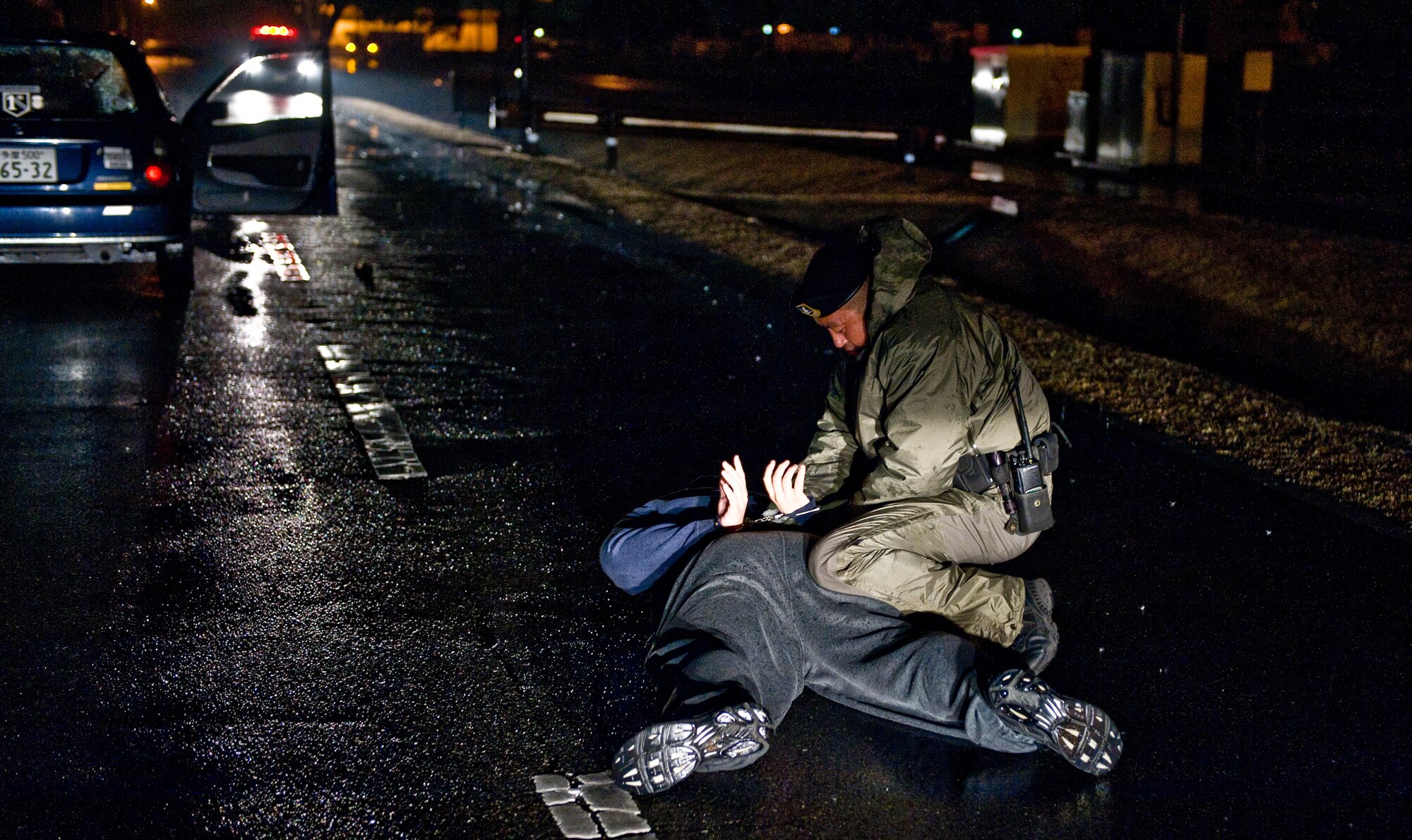 YOKOTA AIR BASE, Japan -- A 374th Security Forces patrolman apprehends a suspect during an operational readiness exercise at Yokota Air Base, Japan, Feb. 23, 2012. Patrolmen were evaluated on their ability to apprehend a suspect during a simulated gate running incident occurred. (U.S. Air Force photo/Airman 1st Class Krystal M. Garrett) 