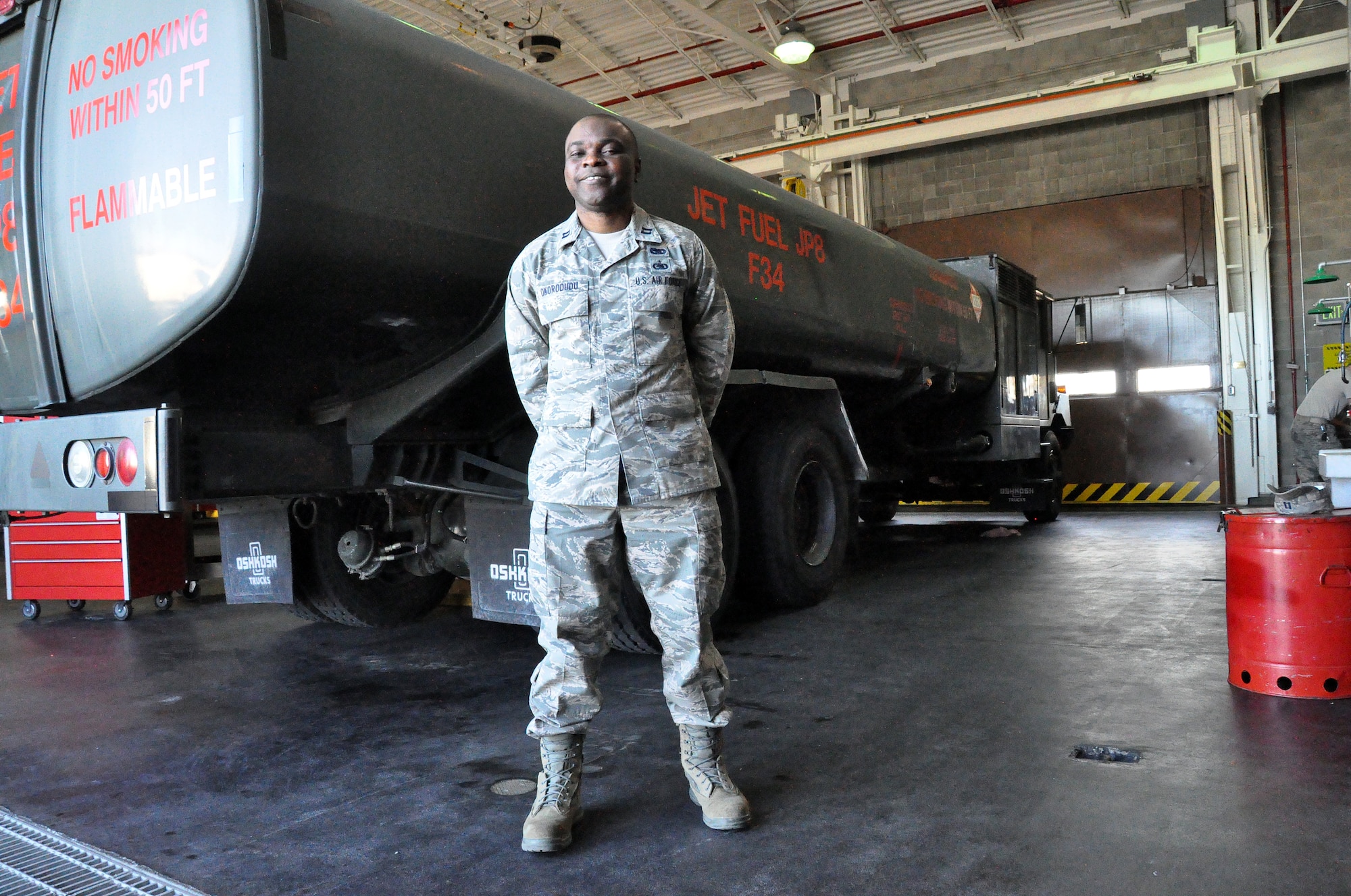 Capt. George Okorodudu, 60th Logistics Readiness Squadron fuels flight commander, stands in front of one of the fuel tankers Feb. 22 on Travis. (U.S. Air Force photo/Airman 1st Class Madelyn Ottem)