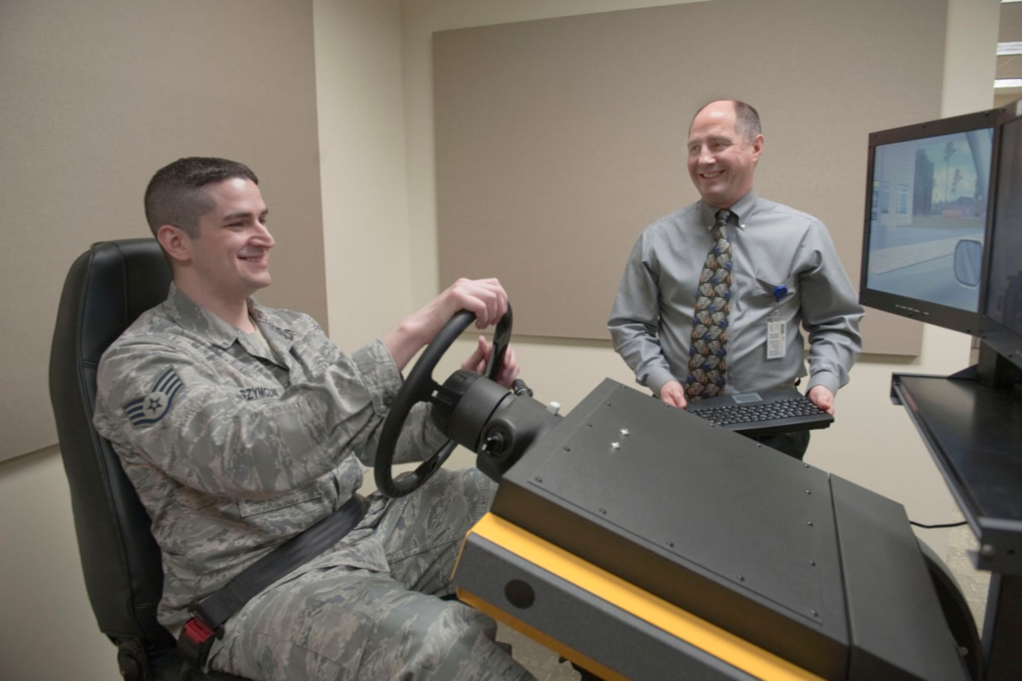 Rick Vandegrift observes Air Force Staff Sgt. Robert Szymczak operate a Virtual Learning Driving Simulator in the Traumatic Brain Injury Clinic, Feb. 17, 2012, part of the Lynx Wing mental health clinic on Joint Base Elmendorf-Richardson. The simulator helps establish if the patient is capable of driving, their level of attention to detail, their reaction times and evaluates their visual processing of information. Szymczak is NCOIC of the mental health center resiliency element and native of Durand, Mich. Vandegrift is a certificed occupational therapy technician for the Traumatic Brain Injury Clinic and native of Bozeman, Mont. (U.S. Air Force photo/Staff Sgt. Robert Barnett)