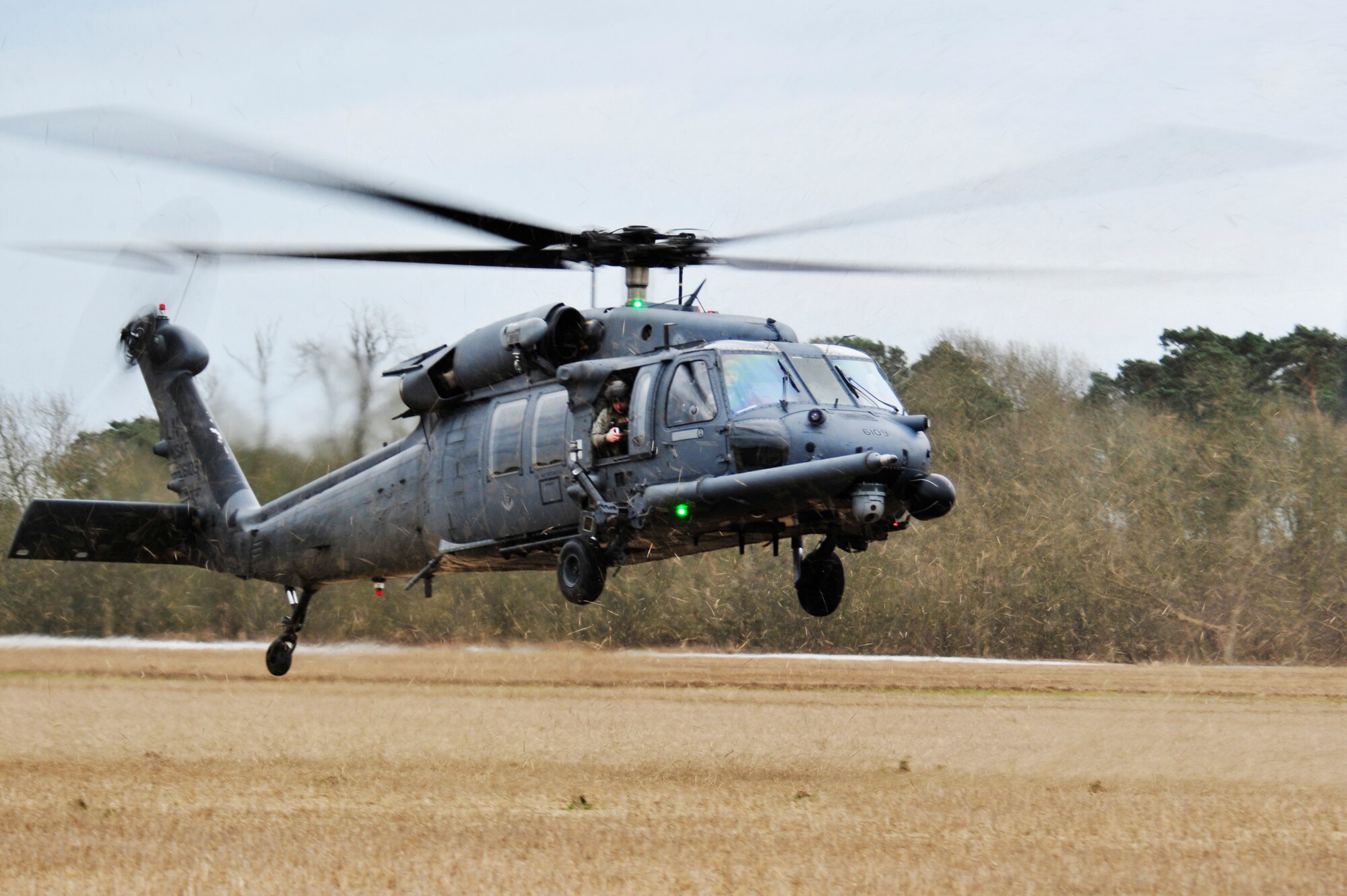 STANFORD TRAINING AREA, England – An HH-60G Pave Hawk prepares to land after pararescuemen from the 56th Rescue Squadron parachuted out, Feb. 15, 2011. The pararescuemen were performing static line jumps, which involves a mechanism that opens a parachute automatically with no action required by the passenger. This is the first time that the 56th RQS has performed static line jumps since being stationed at Royal Air Force Lakenheath. (U.S. Air Force photo by Senior Airman Tiffany M. Deuel)