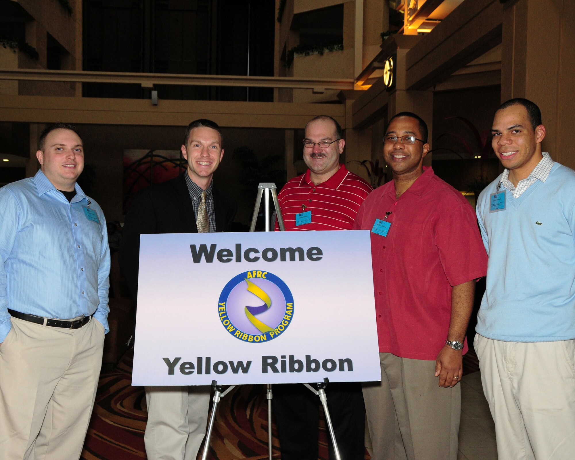 Yellow Ribbon greeters (left to right) Staff Sgt. Jordan Romney, 914th Airlift Wing command support specialist; Tech. Sgt. Larry Marsh, 932nd Airlift Wing command post technician; Master Sgt. Martin Viggato, 914th Airlift Wing Family Readiness NCOIC; Tech. Sgt. Marlon Crawford, 932nd Force Support Squadron education and training specialist; and Staff Sgt. Jeffery Sherman, 88th Aerial Port Squadron passenger services specialist, pose for a group photo at the Yellow Ribbon Reintegration Program event held in Jacksonville, Florida February 17-19, 2012. The Yellow Ribbon event is a DoD program designed to promote the well-being of National Guard and Reserve members, their families, and communities by connecting them with resources before, during, and after deployments. Topics covered during this event included information on VA and Tricare benefits, financial planning for deployment, Military One Source, Key Spouse program, legal, spiritual, education, and stress management.  (U.S. Air Force photo by Peter Borys)
