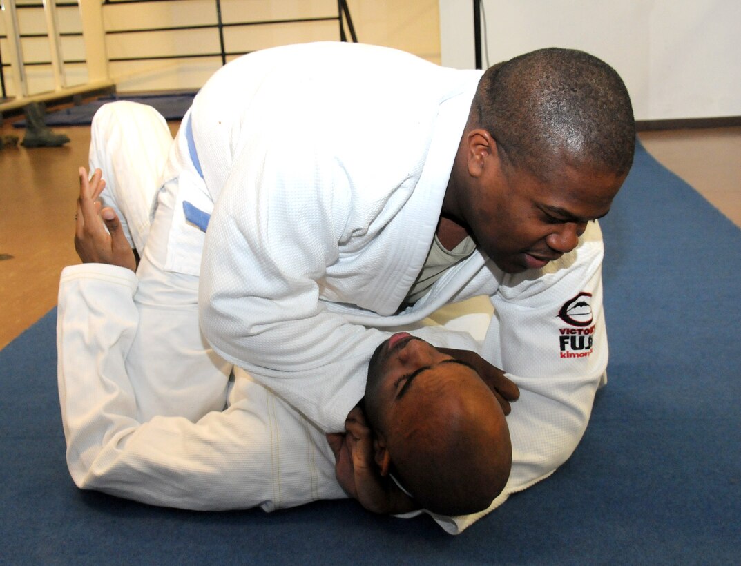 Tech. Sgt. Chales Baker (above), 17th Air Force, puts an Ezekiel choke on Tech. Sgt. Ricardo Henry, 603rd Air and Space Operations Center, during a training session. The choke was Baker's wining move at the recent International Brazilian Jiu-Jitsu Foundation's European Open in Lisbon, Portugal. Baker and Henry are both members of Ramstein Brazilian Jiu-Jitsu. (U.S. Air Force photo/Master Sgt. Jim Fisher)
