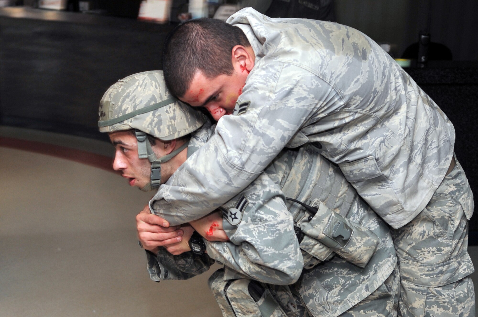 Airman 1st Class Benjamin Castillo, 51st Security Forces Squadron member, performs a pack-strap carry method to remove a simulated wounded individual out of a building here, Feb. 22, 2012. Castillo was performing his duties during an active shooter Emergency Management Exercise.  (U.S. Air Force photo/Staff Sgt. Craig Cisek)