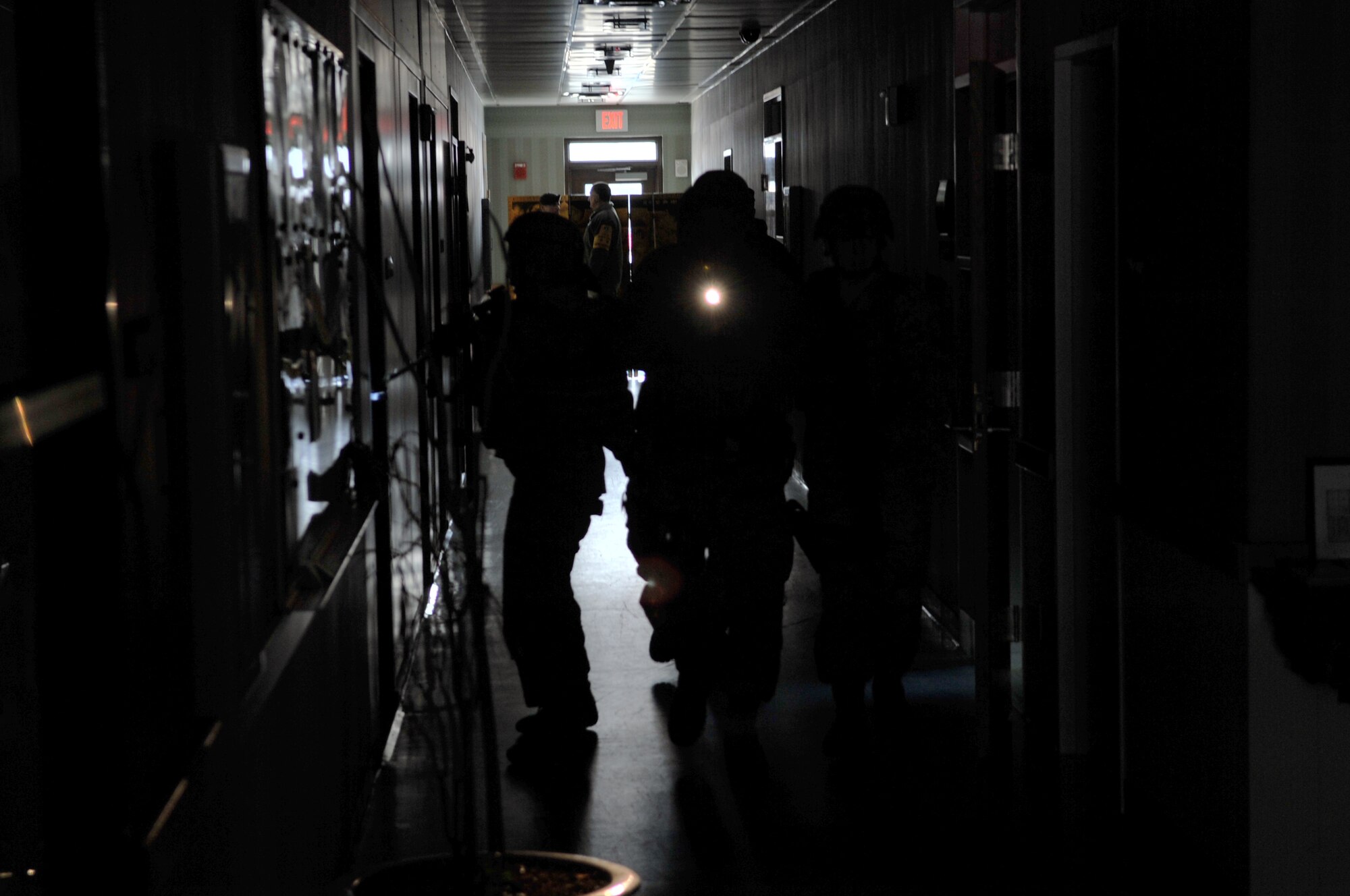 51st Security Forces Squadron Airmen do a complete sweep of a building to ensure there are no active hostiles during an Emergency Management Exercise here, Feb. 22, 2012. The EME went over roles and precautions of a potential active shooter scenario.   (U.S. Air Force photo/Staff Sgt. Craig Cisek)