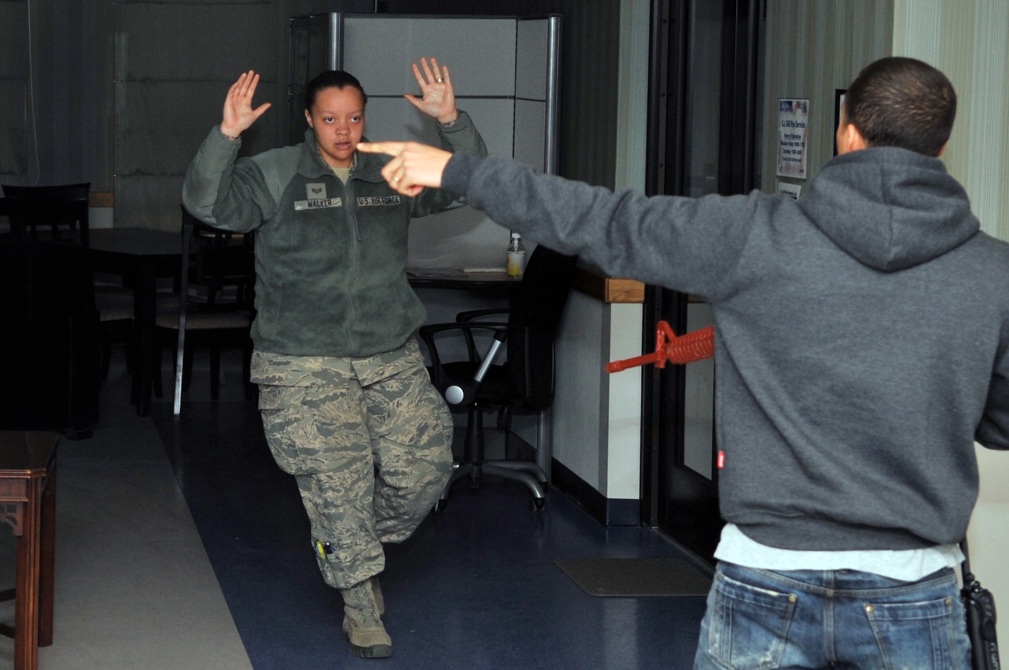 Staff Sgt. Byron Price, 51st Security Forces Squadron member, directs a hostage to a more confined area, Feb. 22, 2012. Price acted as a role player during an Emergency Management Exercise here. (U.S. Air Force photo/Staff Sgt. Craig Cisek)