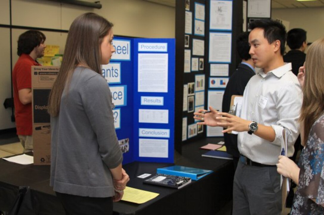 GEORGIA — Jimmy Luo, an electrical engineer with the U.S. Army Corps of Engineers Savannah District, interviews a student about her science project at the Georgia Tech Regional Science and Engineering Fair, Feb. 15, 2012.