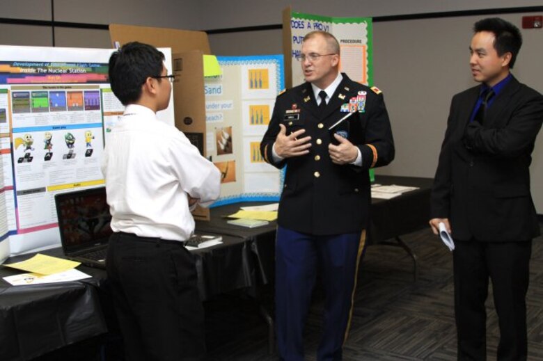 GEORGIA — Col. Jeff Hall, commander of the U.S. Army Corps of Engineers Savannah District, and Jimmy Luo, an electrical engineer at the Corps' Fort Stewart field office, speak with a student about his science project at the 2012 Georgia Tech Regional Science and Engineering Fair, Feb. 16, 2012.
