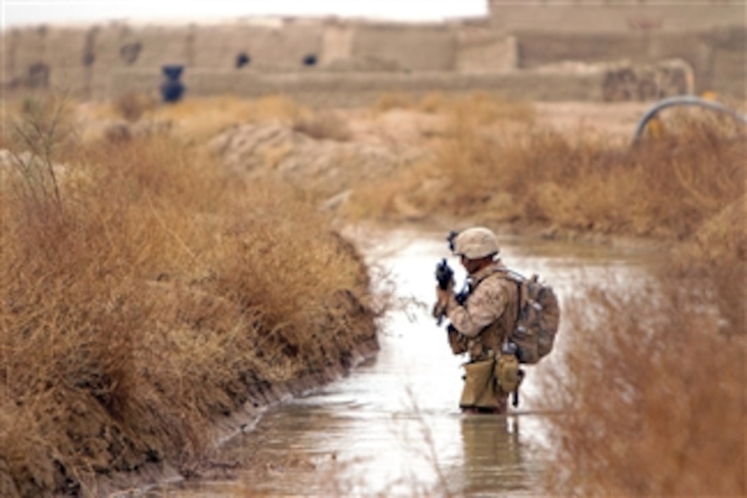 U.S. Marine Corps Sgt. Guillermo Floresmartines wades through a canal during a patrol around the villages of Sre Kala and Paygel in Helmand province, Afghanistan, on Feb. 16, 2012.  Floresmartines is an assistant squad leader assigned to Alpha Company, 1st Light Armored Reconnaissance Battalion.  U.S. Marines and sailors conducted clearing and disrupting operations around the villages during Operation Highland Thunder.  