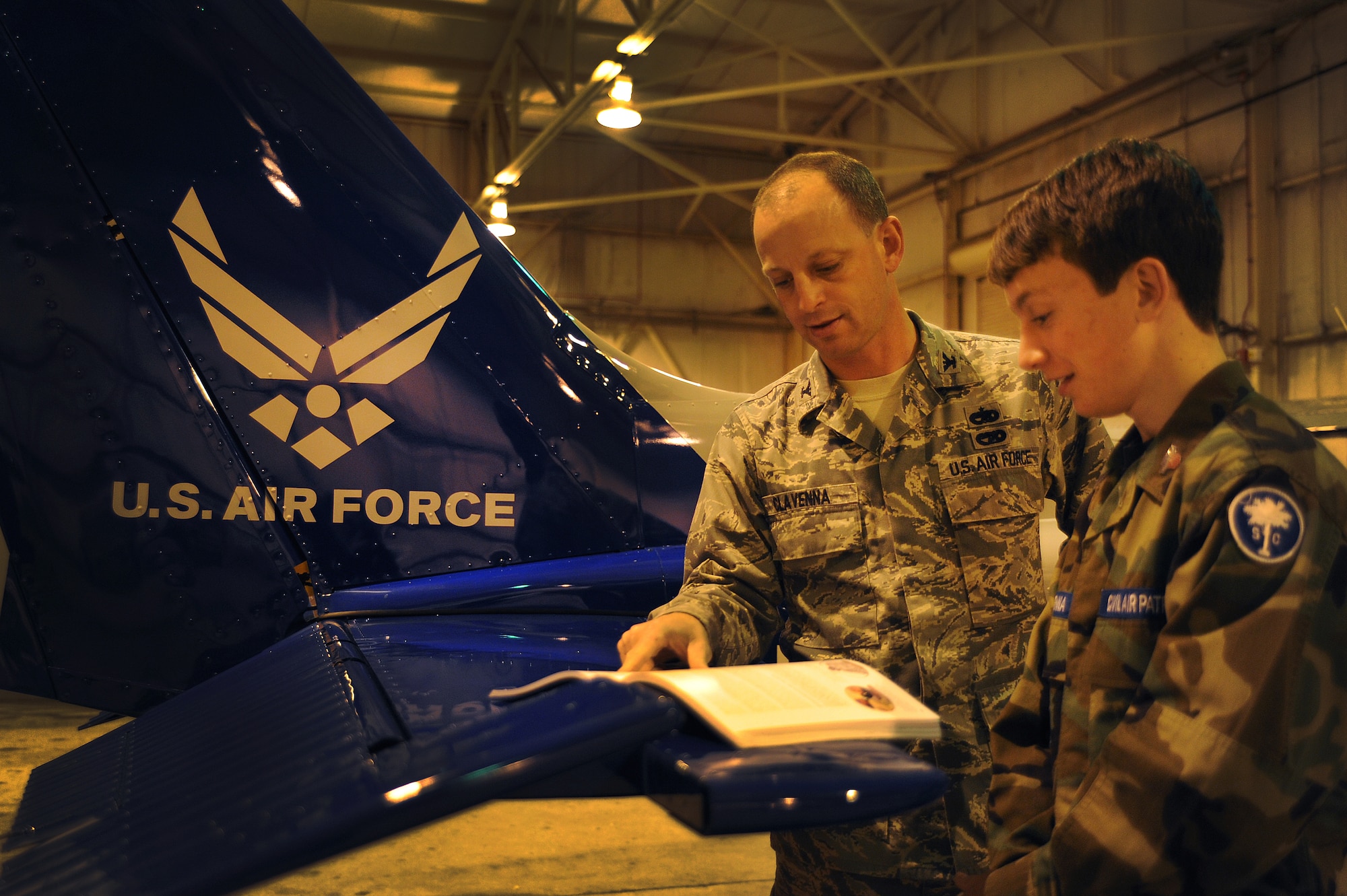 Cadet Airmen Jack Clavenna and father Col. James Clavenna read the Civil Air Patrol Leadership Manual to  at the Coastal Charleston Composite Squadron, Joint Base Charleston - Air Base Feb. 13. Clavenna takes his son to weekly CAP meetings. The Civil Air Patrol has one of the largest fleets of single-engine aircraft in the world, with more than 550 aircraft nationwide. Clavenna is the commander of the 437th Maintenance Group, 437th Airlift Wing. Jack has been in CAP for nearly a year. (U.S. Air Force photo/Airman 1st Class Ashlee Galloway)