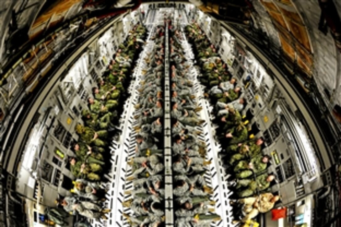Army paratroopers and Canadian soldiers fill the cargo area of a Globemaster III aircraft during a joint operational access exercise on Pope Field, N.C., Feb. 9, 2012. The paratroopers are assigned to the 82nd Airborne Division's 3rd Brigade Combat Team.
