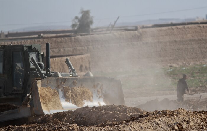 A 3rd Combat Engineer Battalion bulldozer flattens rubble during a patrol base reduction, Feb. 23. The Marines of 3rd CEB built new walls and destroyed unnecessary structures for the Afghan National Civil Order Police. The battalion worked closely with the ANCOP in deciding what the PB should look like.
