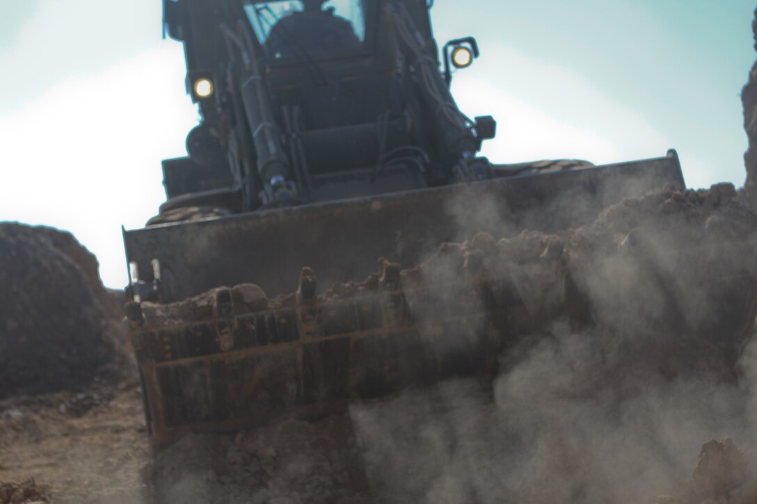 A 3rd Combat Engineer Battalion bulldozer rams through rubble during a patrol base reduction operation, Feb. 23. With fewer men stationed at the patrol base the Afghan National Civil Order Police and Marines there needed less walls and more visibility. The Marines of 3rd CEB spent 3 days tearing down buildings and building new walls.
