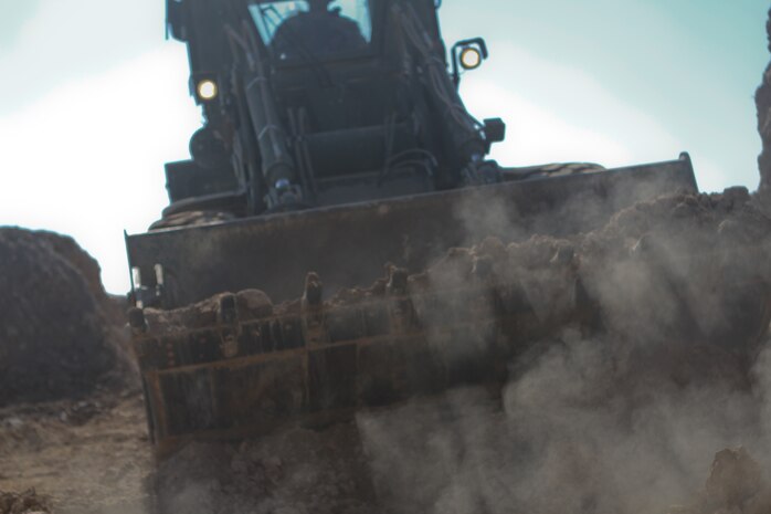 A 3rd Combat Engineer Battalion bulldozer rams through rubble during a patrol base reduction operation, Feb. 23. With fewer men stationed at the patrol base the Afghan National Civil Order Police and Marines there needed less walls and more visibility. The Marines of 3rd CEB spent 3 days tearing down buildings and building new walls.