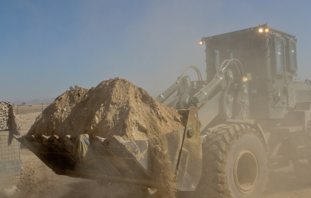 A 3rd Combat Engineer Battalion bulldozer moves dirt to reinforce a newly built wall, Feb. 23. The battalion tore down or reduced more than 12 patrol bases during the last months. With fewer men stationed in the area, the need to scale down bases was a primary mission for 3rd CEB.