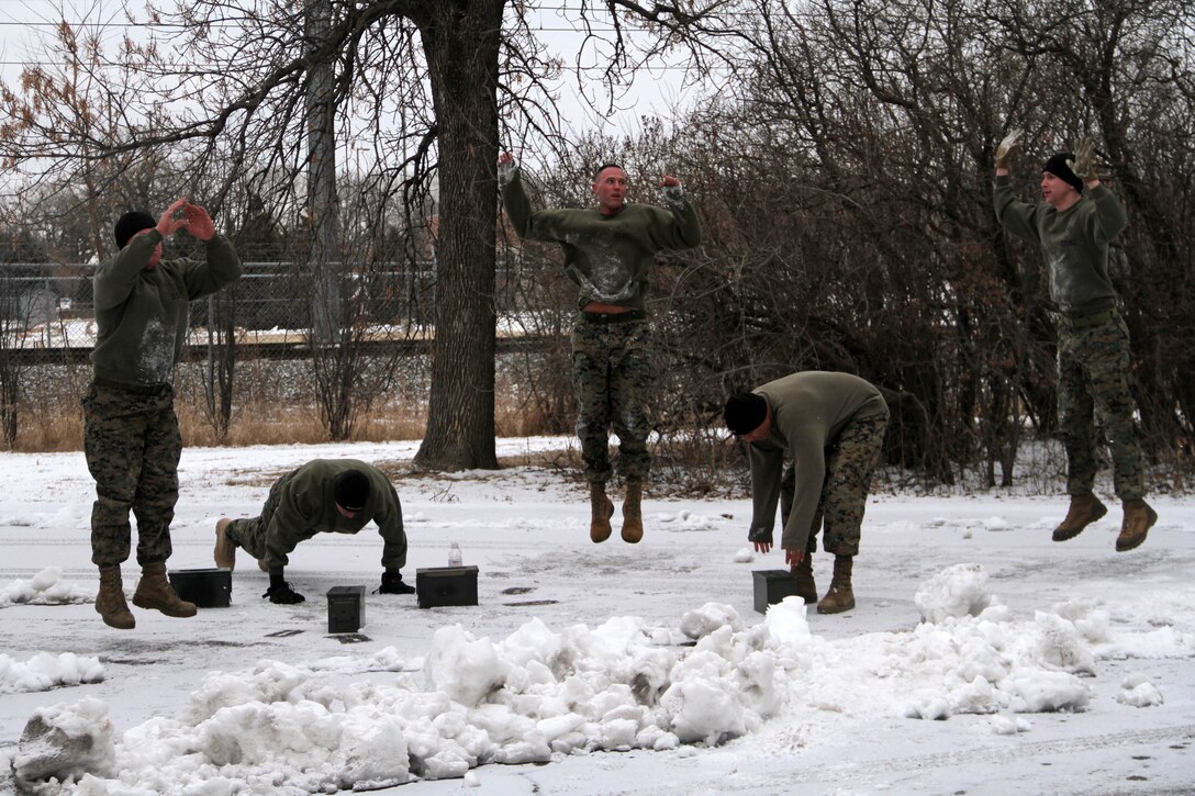 Recruiter Instructor Master Sgt. Michael Reuland and Marines with Recruiting Substation Rochester perform burpees during a Recruiting Station Twin Cities all hands physical training session Feb. 24. For additional imagery from the event, visit www.facebook.com/rstwincities.