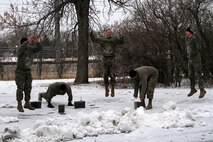 Recruiter Instructor Master Sgt. Michael Reuland and Marines with Recruiting Substation Rochester perform burpees during a Recruiting Station Twin Cities all hands physical training session Feb. 24. For additional imagery from the event, visit www.facebook.com/rstwincities.