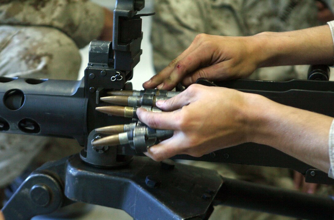 Lance Cpl. Paul Dodd, a field artillery fire control man with 2nd Battalion, 10 Marine Regiment, 2nd Marine Division, loads simulated rounds into a .50 Caliber Machine Gun during a gunner’s course at the Division Training Center aboard Camp Lejeune, N.C., Oct. 26, 2011. Marines with Combat Logistics Battalion 2, Combat Logistics Regiment 2, 2nd Marine Logistics Group, and 2/10 received the training as a part of pre-deployment training for their upcoming tour in support of International Security Assistance Forces in Helmand province, Afghanistan, next year. (U.S. Marine Corps photo by Pfc. Franklin E. Mercado)