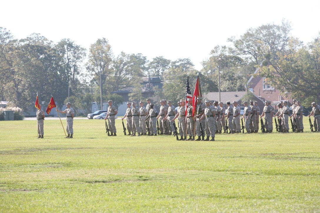 Marines with 3rd Battalion, 9th Marine Regiment, 2nd Marine Division, stand in formation just before a change of command ceremony for the battalion. During the ceremony, 3/9 bid farewell to Lt. Col. David Hudspeth and welcomed Lt. Col. Carl Cooper. 