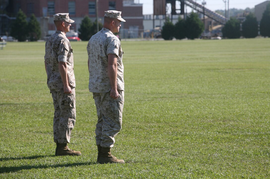 Lt. Col. David Hudspeth, former commanding officer for 3rd Battalion 9th Marine Regiment, 2nd Marine Division, and Lt. Col. Carl Cooper, incoming commanding officer for 3/9, prepare to exchange the colors during a change of command ceremony, Oct. 21. During the ceremony, 3/9 bid farewell to Lt. Col. David Hudspeth and welcomed Lt. Col. Carl Cooper.