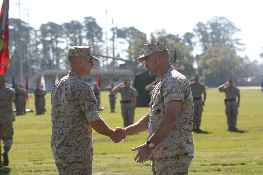 Lt. Col. David Hudspeth, former commanding officer for 3rd Battalion 9th Marine Regiment, 2nd Marine Division, and Lt. Col. Carl Cooper, incoming commanding officer for 3/9, shake hands during a change of command ceremony, Oct. 21. During the ceremony, 3/9 bid farewell to Lt. Col. David Hudspeth and welcomed Lt. Col. Carl Cooper.