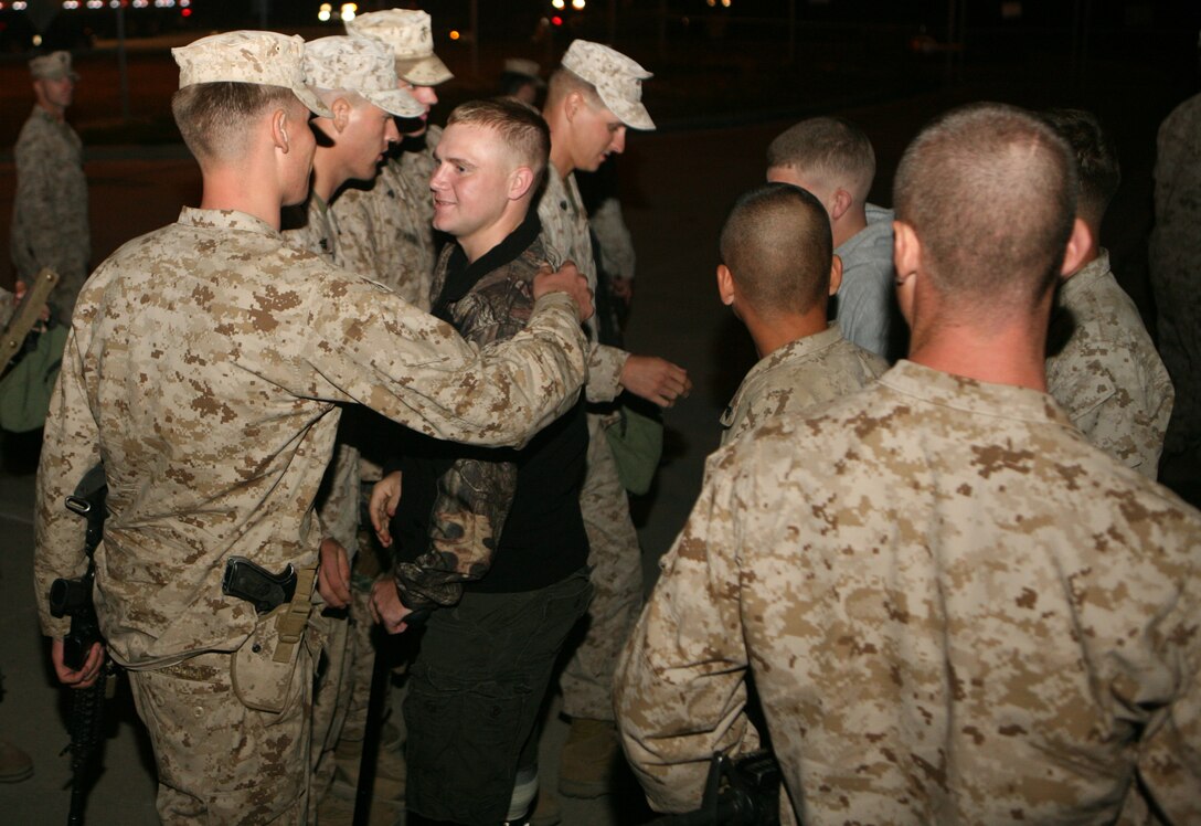 Marines with 2nd Combat Engineer Battalion, 2nd Marine Division, greet other Marines from the same unit who came back early from their deployment due to injuries sustained while deployed in Afghanistan. 2nd CEB returned from a seven month deployment Monday. 