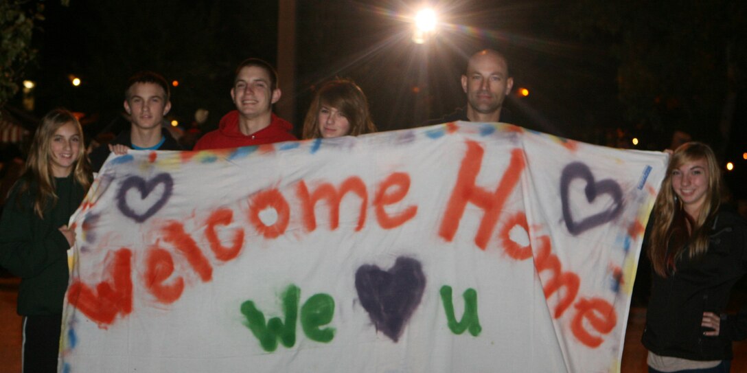 Friends and families of Marines with 2nd Combat Engineer Battalion, 2nd Marine Division, with posters and banners in hand anxiously await the arrival of their loved ones in the early hours of the morning, Oct. 17. The Marines of 2nd CEB returned from a nine month deployment to Afghanistan.