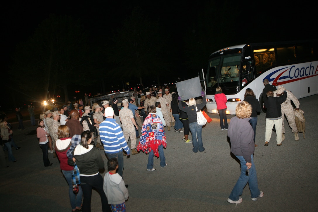 Friends and families of Marines with 2nd Combat Engineer Battalion, 2nd Marine Division, rush toward busses bring their loved one back home to greet them and welcome them home, Oct. 17. 2nd CEB returned from a seven month deployment to Afghanistan.