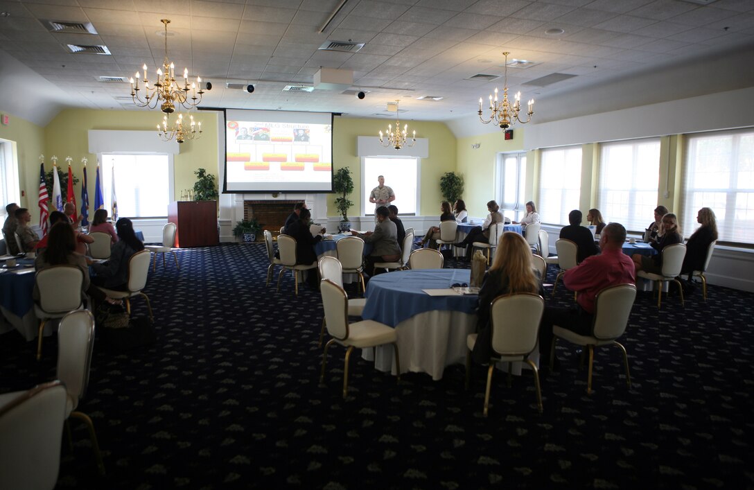 Spouses listen to Lt. Col. Dan Howard, the officer-in-charge of operations with the 2nd Marine Logistics Group explain the unit’s structure during the 2nd MLG Senior Leaders Spouse Orientation tour aboard Camp Lejeune, N.C., Oct. 6, 2011. The day included a period of military education atmosphere, during which spouses were given a brief description of the different sections throughout the 2nd MLG, from the commanding general and sergeant major to the regiments and companies. (U.S. Marine Corps photo by Pfc. Franklin E. Mercado)