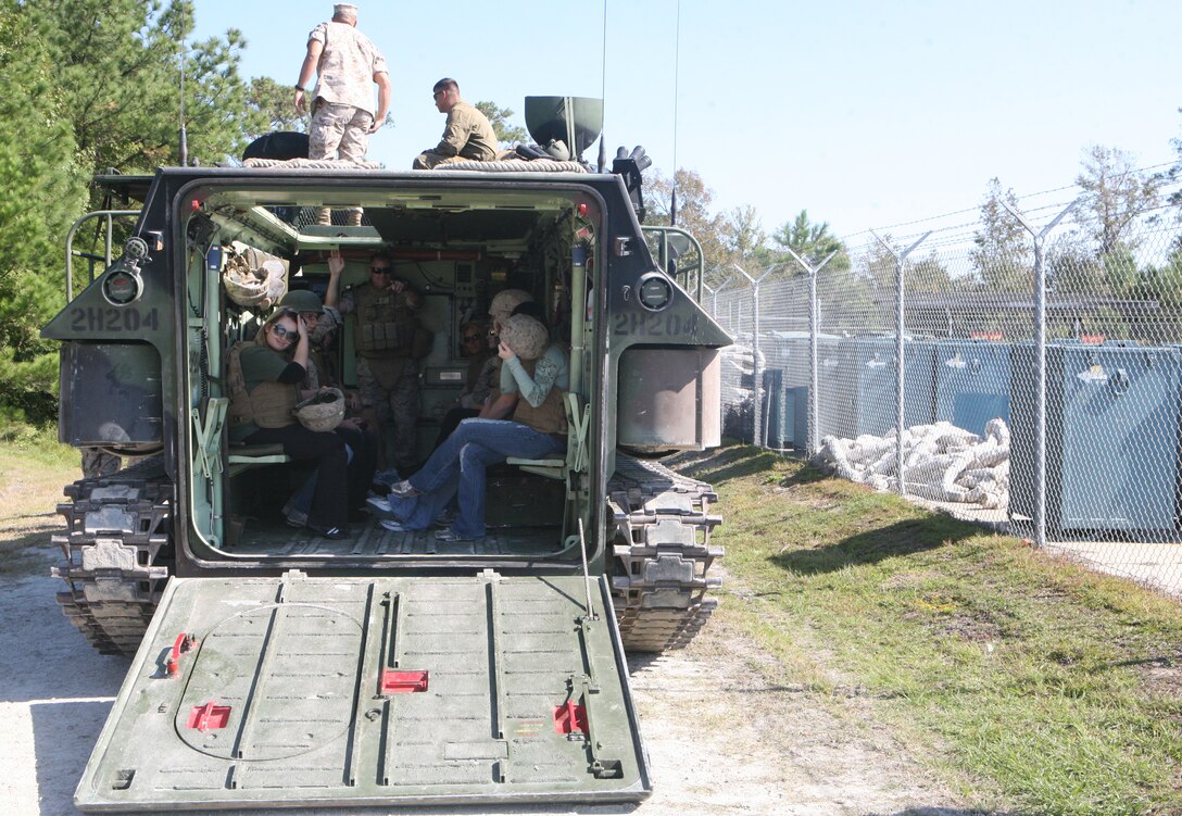 Spouses of Marines with 2nd Amphibious Assault Battalion, 2nd Marine Division, prepare to ride on an amphibious assault vehicle to an obstacle course at Courthouse Bay aboard Marine Corps Base Camp Lejeune, N.C., Oct. 6. The spouses participated in a Jayne Wayne Day to get a taste of Marine life.