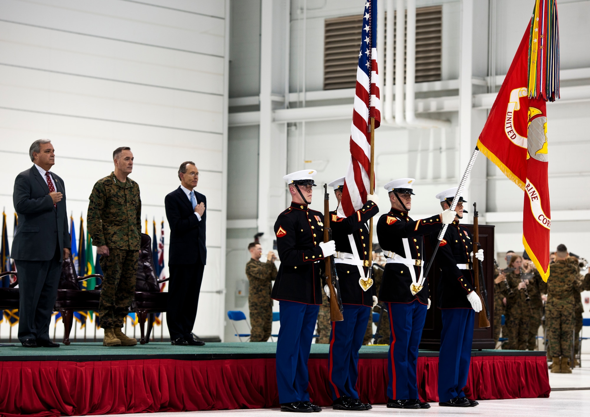 U.S. Congressman Jeff Miller, Assistant Commandant of the Marine Corps. Gen. Joseph Dunford and Chairman and CEO of Lockheed Martin Robert Stevens watch as Marine color guard present the colors during the national anthem at the F-35B Lightning II roll out ceremony Feb. 24 at Eglin Air Force Base, Fla.  (U.S. Air Force photo/Samuel King Jr.)