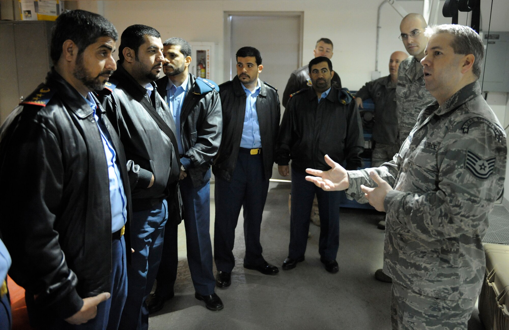 Tech. Sgt. Chad Churchill, survival, evasion, resistance and escape specialist, 66th Training Squadron, briefs military members from the United Arab Emirates armed forces how SERE training helps Airmen prepare for intense situations Feb. 24 at the Fairchild Air Force Base, Wash., aquatic center. (U.S. Air Force photo by Airman 1st Class Earlandez Young)