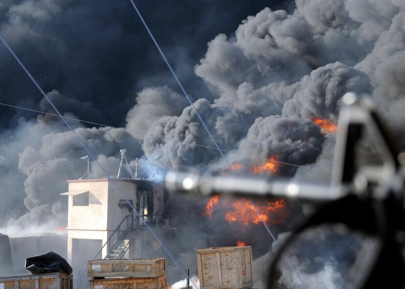 Smoke billows above Forward Operation Base Kalagush, Afghanistan Dec. 28, 2010, during an attack by insurgent forces as shown in this photograph by Senior Airman Chanise Epps of Provincial Reconstruction Team Nuristan. Epps documentation of the event earned her the Airman First Class Darryl G. Winters Combat Communication Award. (U.S. Air Force photo by Senior Airman Chanise Epps) 
