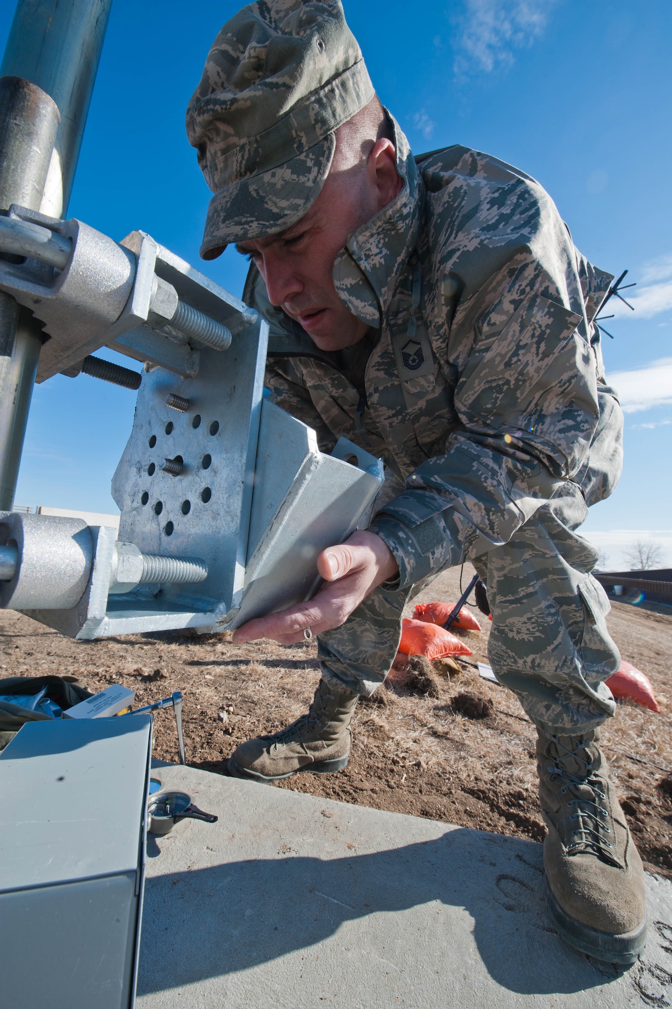 Master Sgt. James Shearer, 28th Communications Squadron transmission system radio maintainer, assembles a AM-1 mount to correctly angle a new helical antenna being installed on Ellsworth Air Force Base, S.D., Feb. 13, 2012. The new antenna is capable of receiving satellite signals to allow continuous, secure data to be sent between military installations thousands of miles away. (U.S. Air Force photo by Airman 1st Class Zachary Hada/Released)