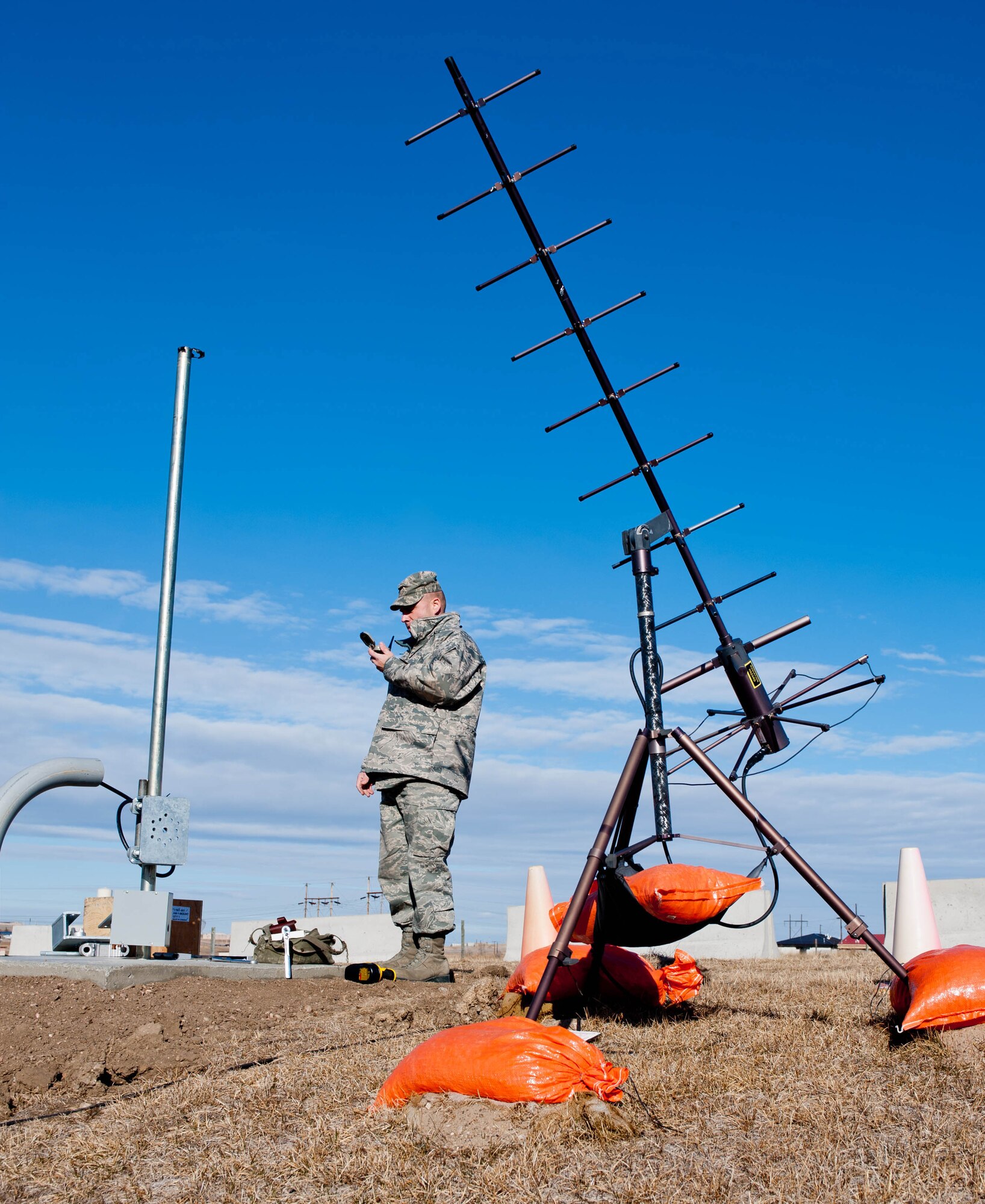 Master Sgt. James Shearer, 28th Communications Squadron transmission system radio maintainer, uses a compass to determine the position for a new helical antenna prior to installation on Ellsworth Air Force Base, S.D., Feb. 13, 2012. Shearer installed the new antenna to secure data transfer between military installations across the U.S. (U.S. Air Force photo by Airman 1st Class Zachary Hada/Released)