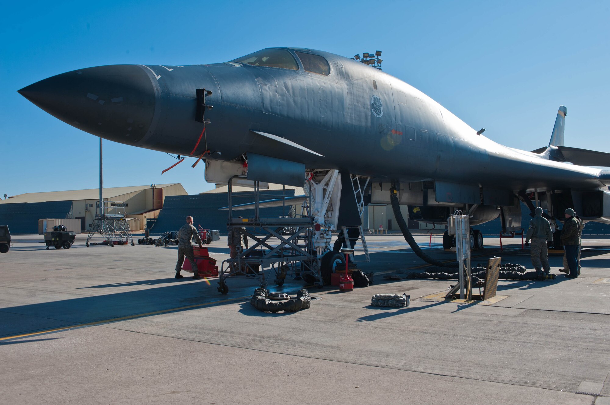 Members of the 28th Maintenance Squadron supply cool air to the interior of a B-1 during an inspection on Ellsworth Air Force Base, S.D., Feb. 16, 2012. Cool air is supplied to ensure the B-1’s interior electrical systems and engines do not overheat while running during maintenance operations. (U.S. Air Force photo by Airman 1st Class Zachary Hada/Released)