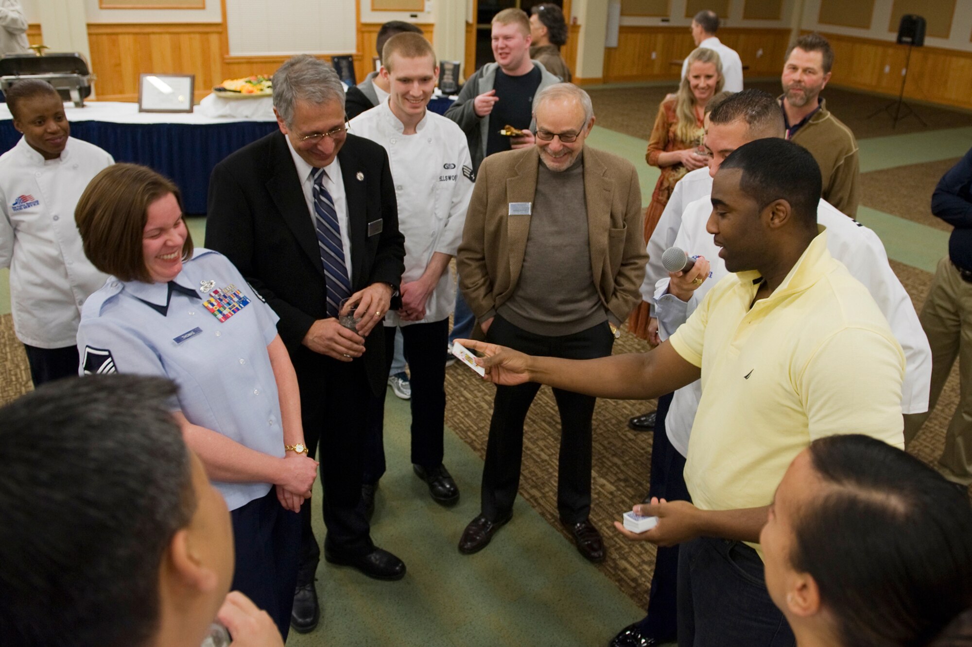 Staff Sgt. Adam Rideaux, 341st Medical Group technician, performs a card trick for the Hennessy inspectors during an ice-breaker event held at the Grizzly Bend Feb. 15. (U.S. Air Force photo/Beau Wade)