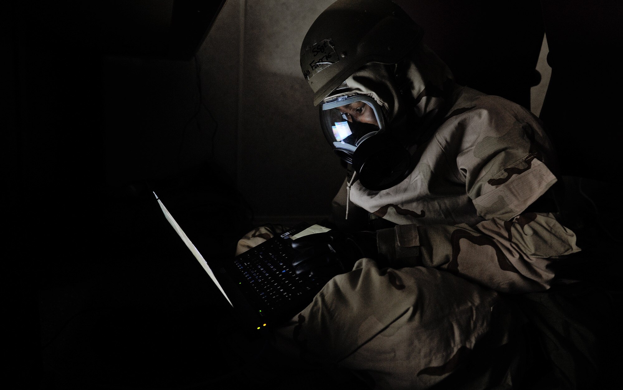 Air Force Staff Sgt. Heslyn Farris, assigned to the 375th Comptroller Squadron, continues to process finance requests in Mission-Oriented Protective Posture 4 as part of an Operational Readiness Exercise held on Scott AFB Feb. 21-25. MOPP 4 is a chemical and biological protective posture declared when an attack is imminent or in progress and when a nuclear, biological or chemical attack is expected or present. OREs are designed to test the base’s ability to conduct operations in a deployed environment. (U.S. Air Force photo by Staff Sgt. Ryan Crane/Released)
