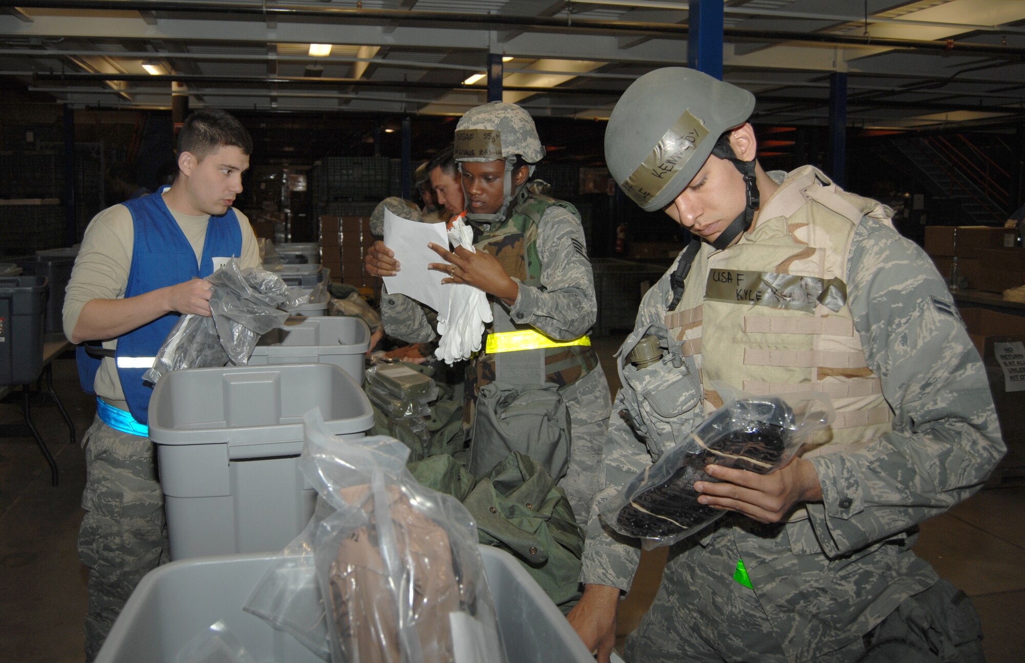U.S. Air Force Airman 1st Class Kyle Kennedy, 355th Civil Engineer Squadron operations management flight, checks to make sure he has all the required items in his mobility bag during the Phase I operational readiness exercise personnel deployment function line at Davis-Monthan Air Force Base, Ariz., Feb. 22. A mobility bag contains items needed for the deployed environment. (U.S. Air Force photo by Airman 1st Class Michael Washburn/Released)