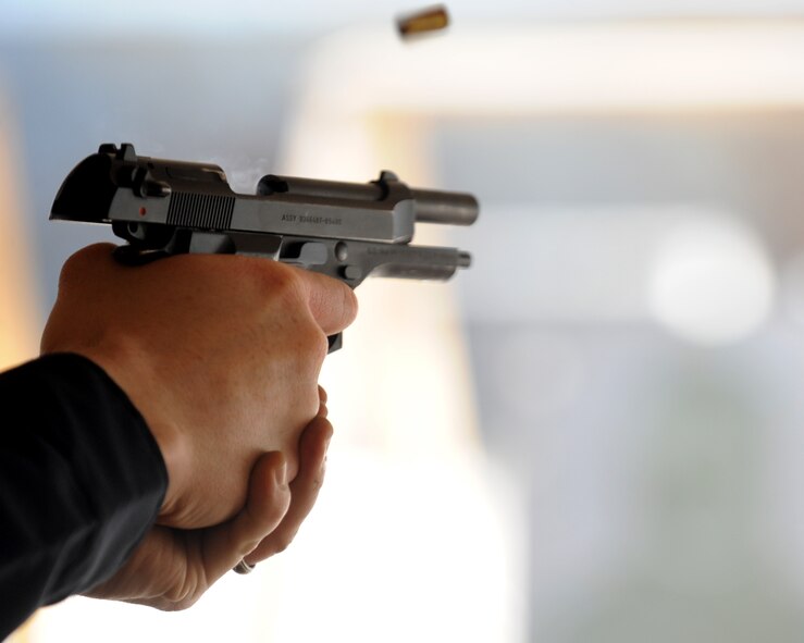 An M-9 berretta is fired Feb. 23, 2012, during an Air Force qualification course, at Dyess Air Force Base, Texas. The new course implements quick reaction with the M-4 carbine and the M-9 beretta. (U.S. Air Force photo by Airman 1st Class Jonathan Stefanko/ Released)