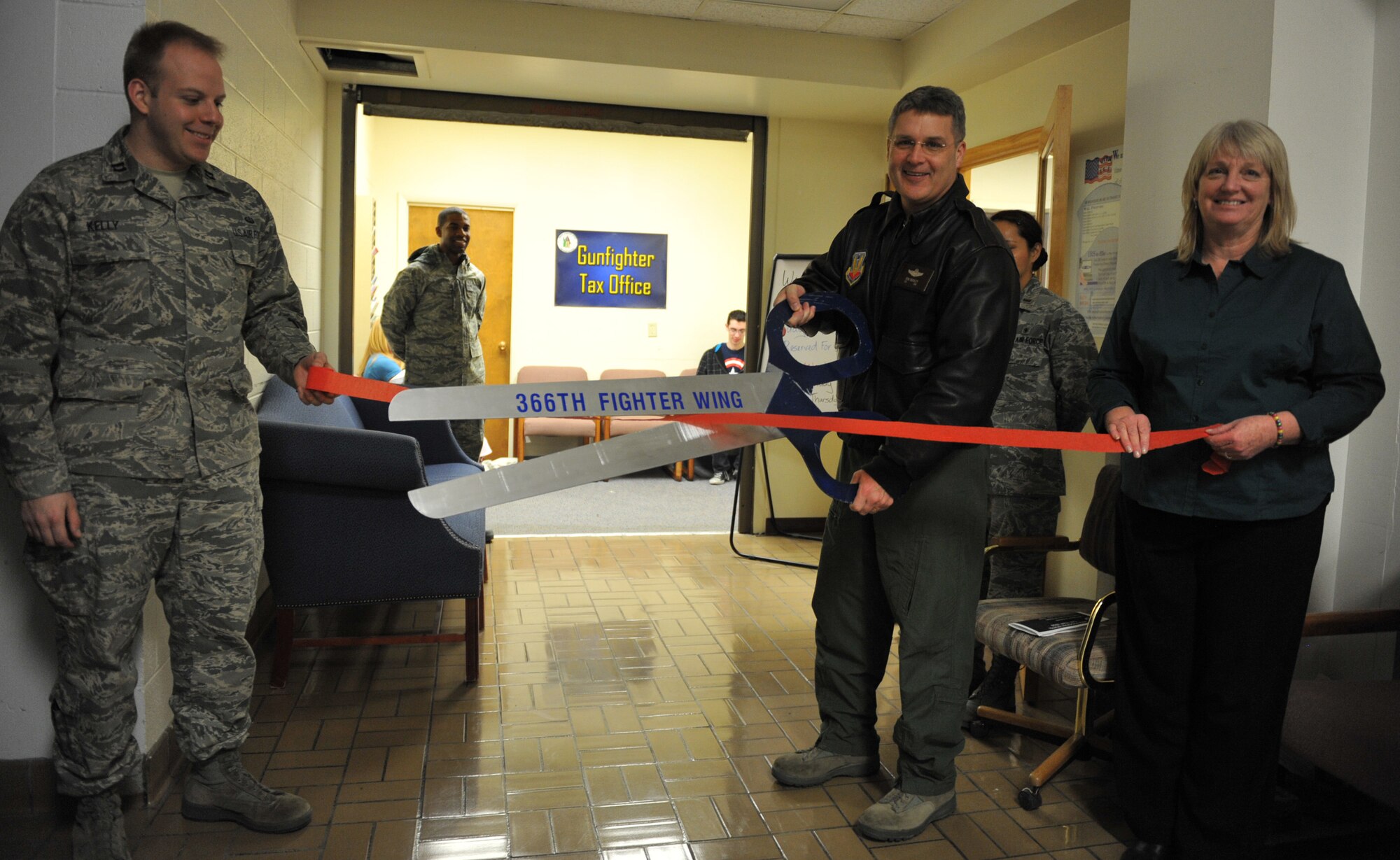 U.S. Air Force Col. Ron Buckley, 366th Fighter Wing commander, cuts a ribbon during the formal opening of the Gunfighter Tax Office Feb. 24, 2012, at Mountain Home Air Force Base, Idaho.  Airmen from several units on base have volunteered their time as income tax assistance representatives and have been trained to e-file federal returns for base personnel. The Tax Center is open each day from 8 a.m. to 3 p.m. with walk-ins on Mondays and Fridays and appointments on Tuesdays and Thursdays. (U.S. Air Force photo by Airman 1st Class Heather Hayward/Released)
