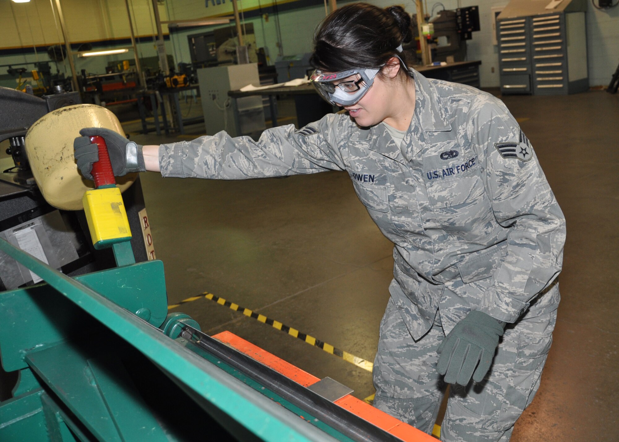 Senior Airman Emilie Owen, aircraft structures specialist, 931st Maintenance Squadron, uses a cornice brake to bend a steel gusset for an aircraft galley. The gusset is a type of bracket that secures two aluminum sides of the galley. After the steel is bent to create the gusset, it will be cut and sanded into the proper shape. (Official photo by Tech. Sgt. Brannen Parrish) 