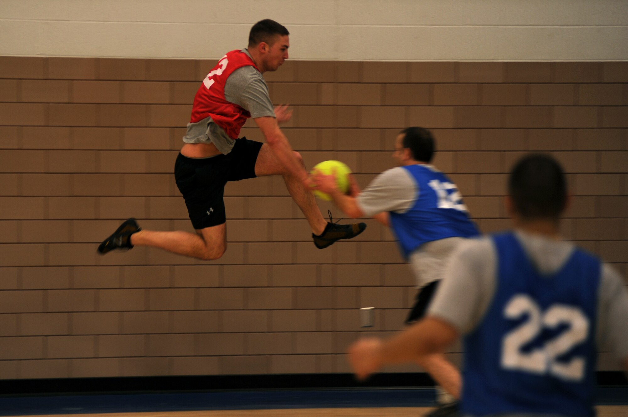 Despite a huge leap, Staff Sgt. Timothy Stencil, 319th Communications Squadron, is tagged out by Master Sgt. Matthew Brown, 319th Logistics Readiness Squadron, during the Flaming Bases competition at the annual Winter Bash on Grand Forks Air Force Base, N.D., on Feb 23, 2012. (U.S. Air Force photo by Staff Sgt. Amanda N. Grabiec)