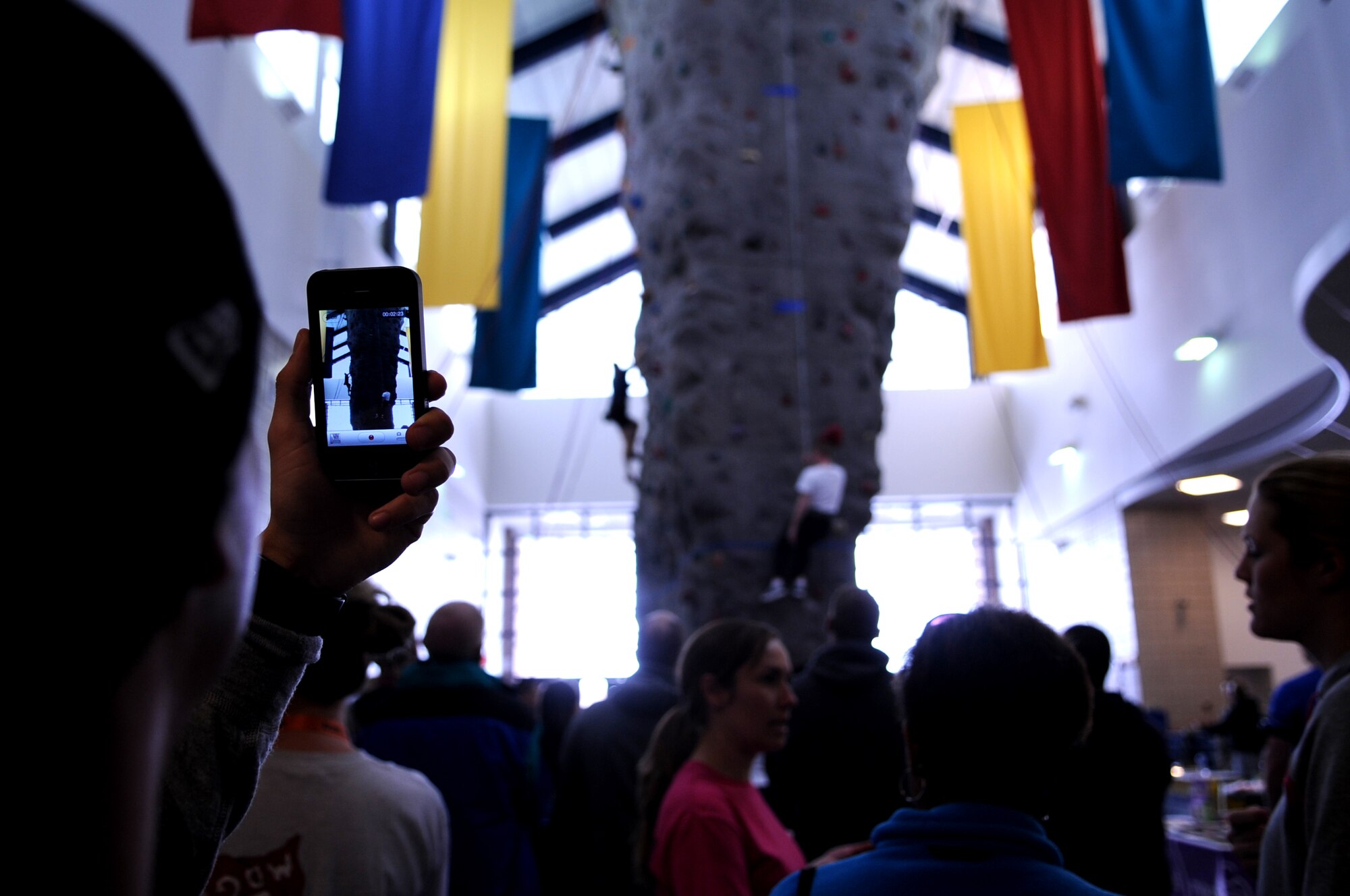 An Airman from Grand Forks Air Force Base takes a video during the Glacier Speed Climb competition at the annual Winter Bash on Feb 23, 2012. When the final points were tallied, the 319th Civil Engineer Squadron came out on top, barely slipping past the second-place 319th Logistics Readiness Squadron. (U.S. Air Force photo by Staff Sgt. Amanda N. Grabiec)
