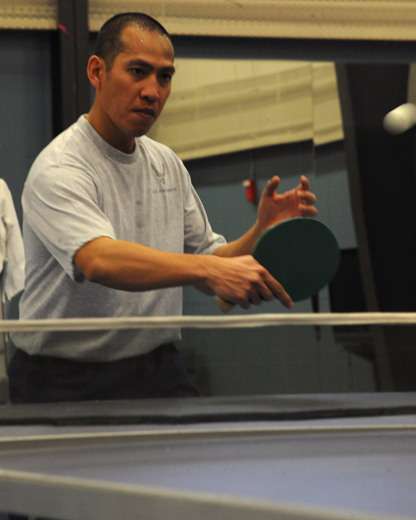 Capt. Angeles Deleon, 319th Air Base Wing chaplain, anticipates the trajectory of a ping pong ball during a match Feb. 23, 2012, during the annual Winter Bash on Grand Forks Air Force Base, N.D. (U.S. Air Force photo by Airman 1st Class Xavier Navarro)