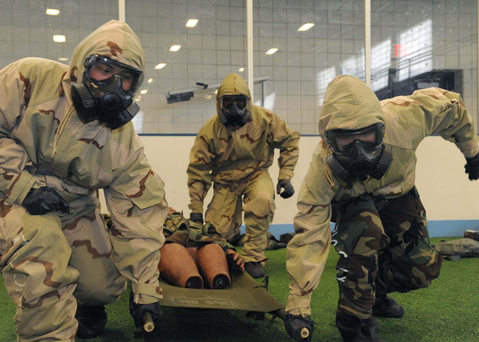 Members of the 319th Logistics Readiness Squadron race across the field during a chemical, biological, radiological, nuclear and enhanced conventional weapons challenge at the Winter Bash on Feb. 23, 2012, on Grand Forks Air Force Base, N.D. (U.S. Air Force photo by Senior Airman Amber Bennett)