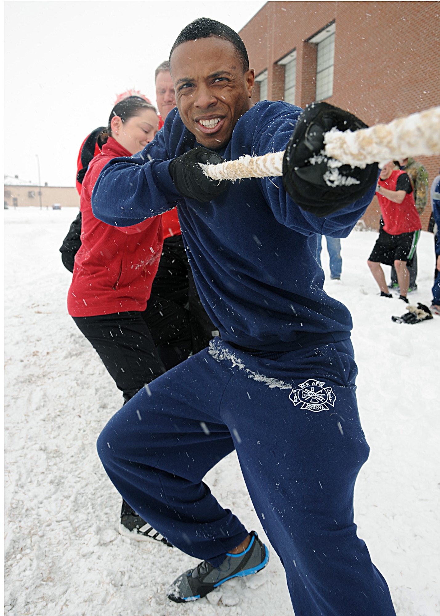 Members of the 319th Civil Engineer Squadron battle it out during a tug-of-war competition at the Winter Bash on Feb. 23, 2012, on Grand Forks Air Force Base, N.D.  (U.S. Air Force photo by Senior Airman Amber Bennett)